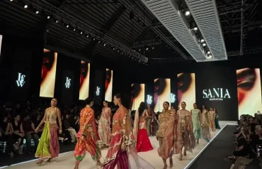 LAAM Fashion Week Season 2 Day 2 runway show in Lahore featuring a model in traditional attire against an illuminated architectural backdrop celebrating Pakistani fashion and heritage.
